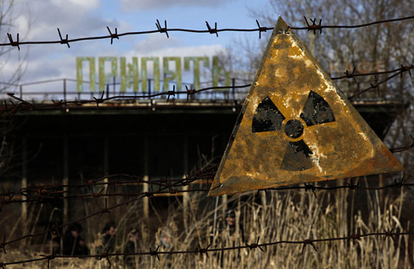 A radioactive sign hangs on barbed wire outside a cafÈ in Pripyat.